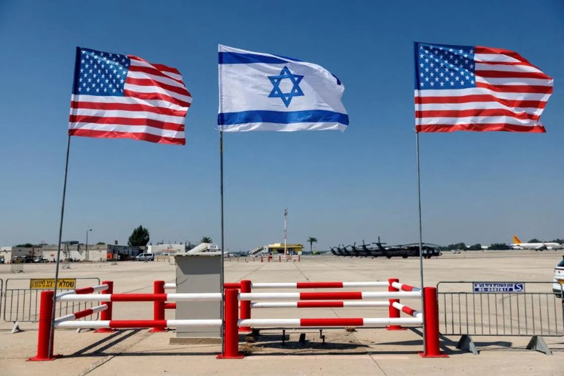 FILE PHOTO: Israeli and American flags stand during the final rehearsal for the ceremony to welcome U.S. President Joe Biden ahead of his visit to Israel, at Ben Gurion International airport, in Lod near Tel Aviv, Israel July 12, 2022. REUTERS/Amir Cohen/File Photo