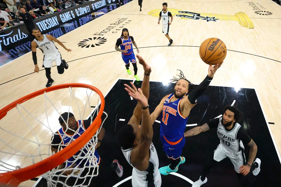 Jun 13, 2026; San Antonio, Texas, USA; New York Knicks guard Jalen Brunson (11) drives to the basket past San Antonio Spurs forward Julian Champagnie (30) during game five of the 2026 NBA Finals at Frost Bank Center. Mandatory Credit: Geoff Burke-Pool Photo via Imagn Images