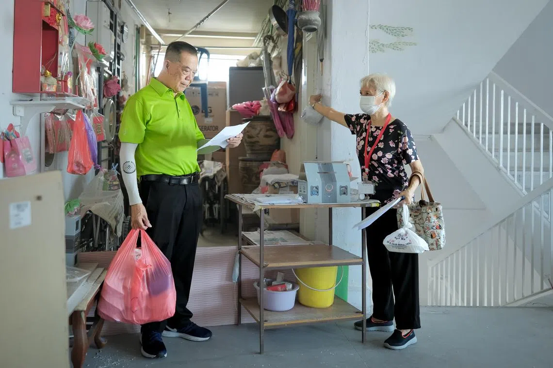 Mr Shue Teng Lee, 72, and Madam Green Lillian Janet, 83, from THK Active Aging Centre @ Macpherson delivering food to nearby residents, June 22, 2023.