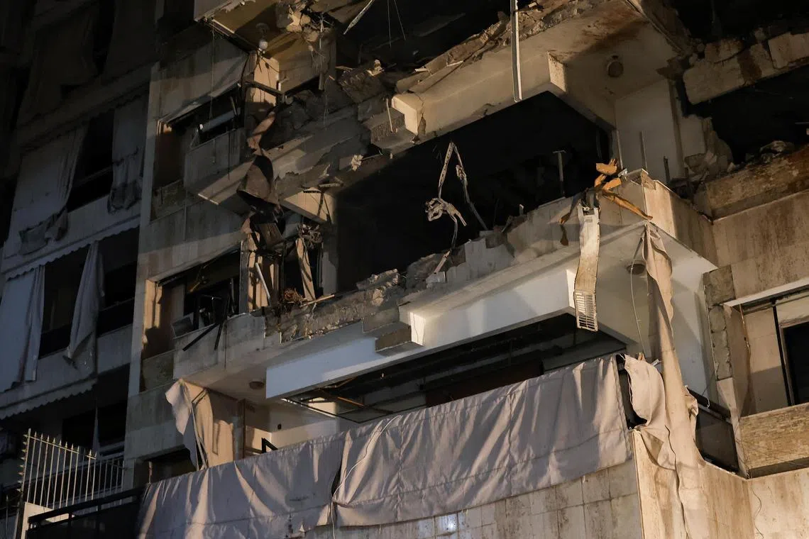 A damaged building stands at the site of an Israeli air strike, amid ongoing hostilities between Hezbollah and Israeli forces, in Beirut on Oct 10. 