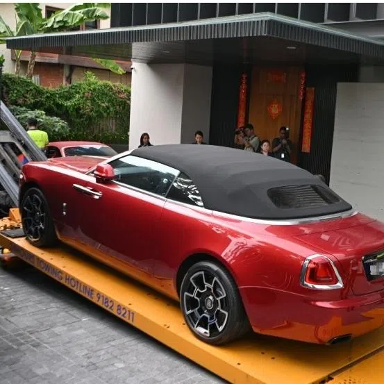 (Clockwise from top left) A red Rolls-Royce Dawn, a red Porsche 911 Targa, a white Toyota Alphard and a black Rolls-Royce Cullinan were seized from a good class bungalow in Third Avenue on Oct 25, 2023.