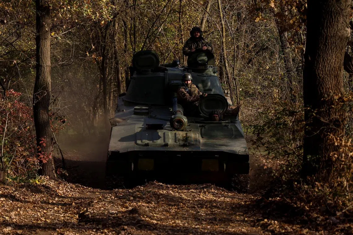 Ukrainian servicemen on a self-propelled howitzer near the frontlines in the Mykolaiv region.