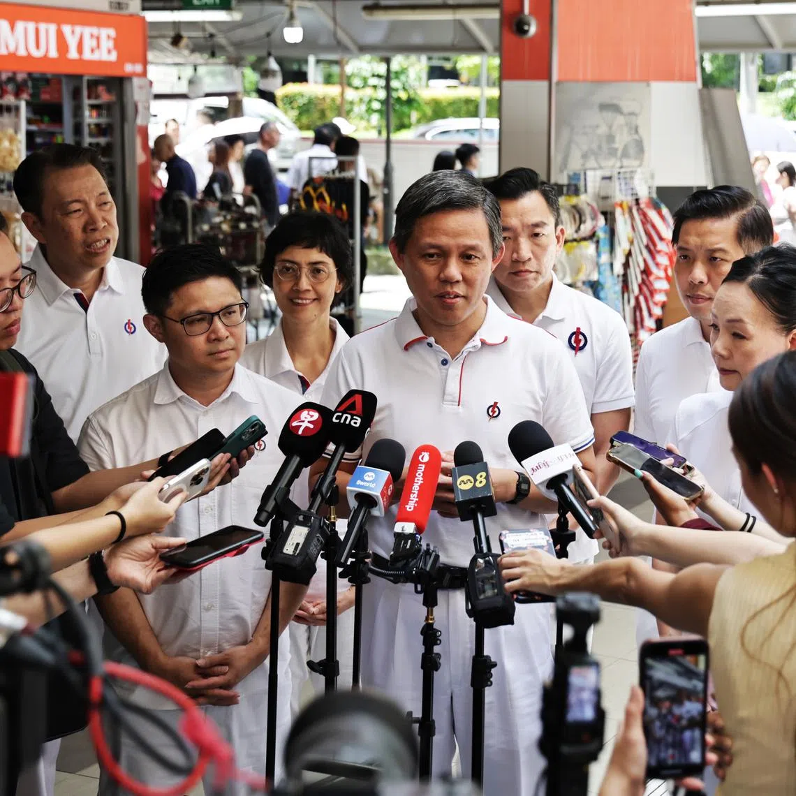 Education Minister Chan Chun Sing (centre) speaking to reporters before a walkabout at Tanjong Pagar Plaza Market and Food Centre on April 30.