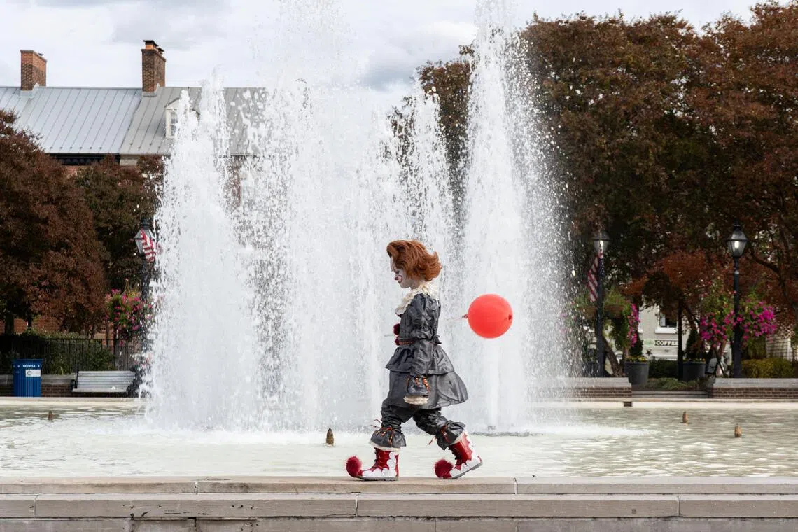 A child dressed as Pennywise, the clown from Stephen King's "It," walks around a fountain during a Halloween trick-or-treat event in Old Town Alexandria, Virginia, U.S., October 25, 2025. REUTERS/Kylie Cooper     TPX IMAGES OF THE DAY     