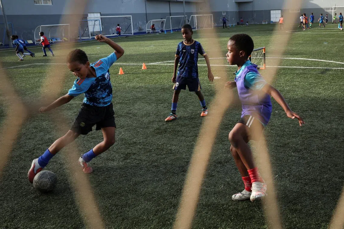 Youth trainees practice during a football training session inside the Bola Pra Frente football academy in Praia, Cape Verde on June 29.