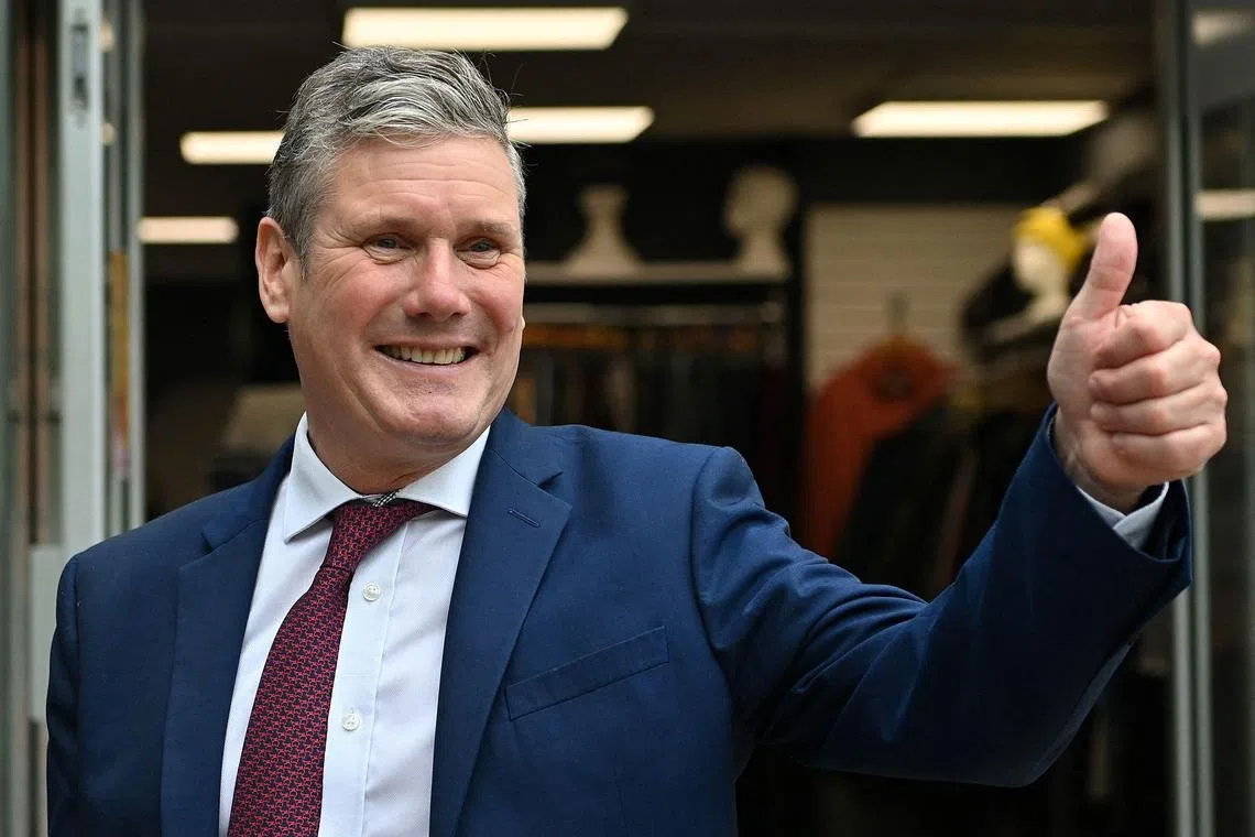 (FILES) Britain's main opposition Labour Party leader Keir Starmer gestures during a visit to local businesses in Hove, west of Brighton on the second day of the annual Labour Party conference in Brighton, on the south coast of England on September 26, 2021. Britain's Labour Party begins its annual conference on Sunday, October 8, eyeing a return to power after more than a decade in opposition in a general election tipped for next year. (Photo by JUSTIN TALLIS / AFP)