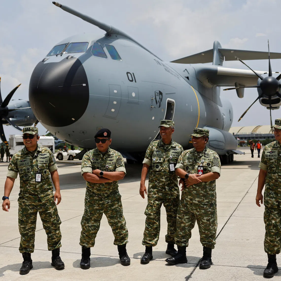 Indonesian Air Force officers stand near an Airbus A400M military plane from France at Halim Perdanakusuma air base, in Jakarta, Indonesia, November 3, 2025. REUTERS/Ajeng Dinar Ulfiana