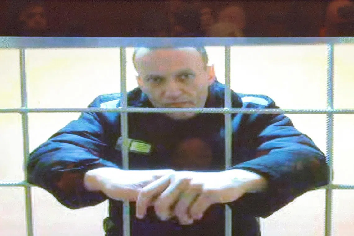 In this file phone, Russian opposition leader Alexei Navalny is seen on a screen via a video link from the IK-2 corrective penal colony in Pokrov during a court hearing to consider an appeal against his prison sentence in Moscow, Russia, on May 24, 2022. 