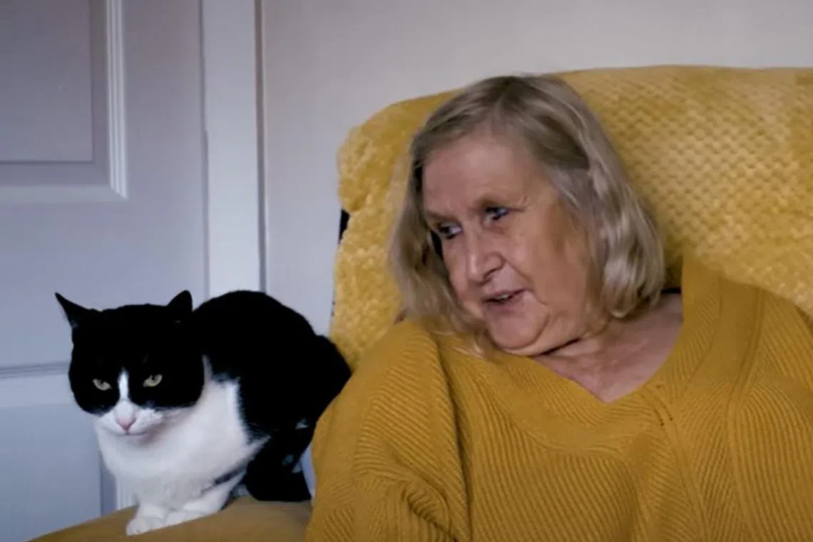 Zebby and his owner Genevieve Moss, who is deaf and lives alone in England. 