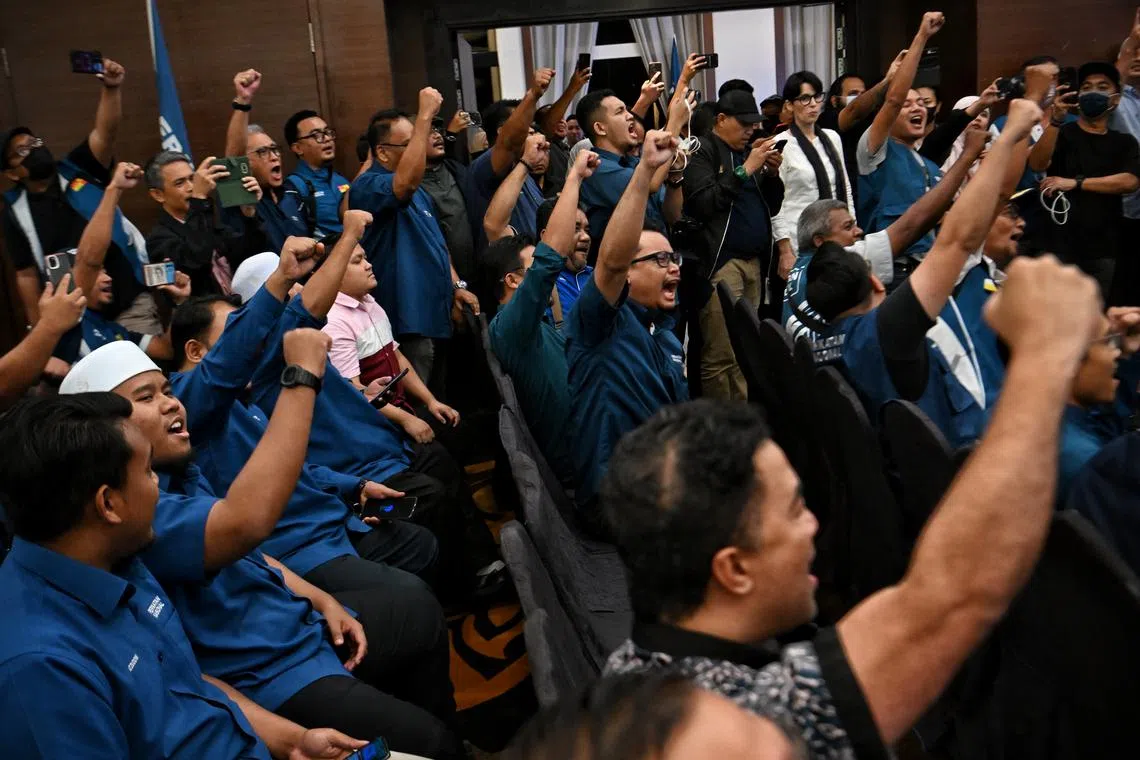 Supporters of Perikatan Nasional cheering as results stream in for Malaysia's 15th general election in Kuala Lumpur on Nov 19, 2022.