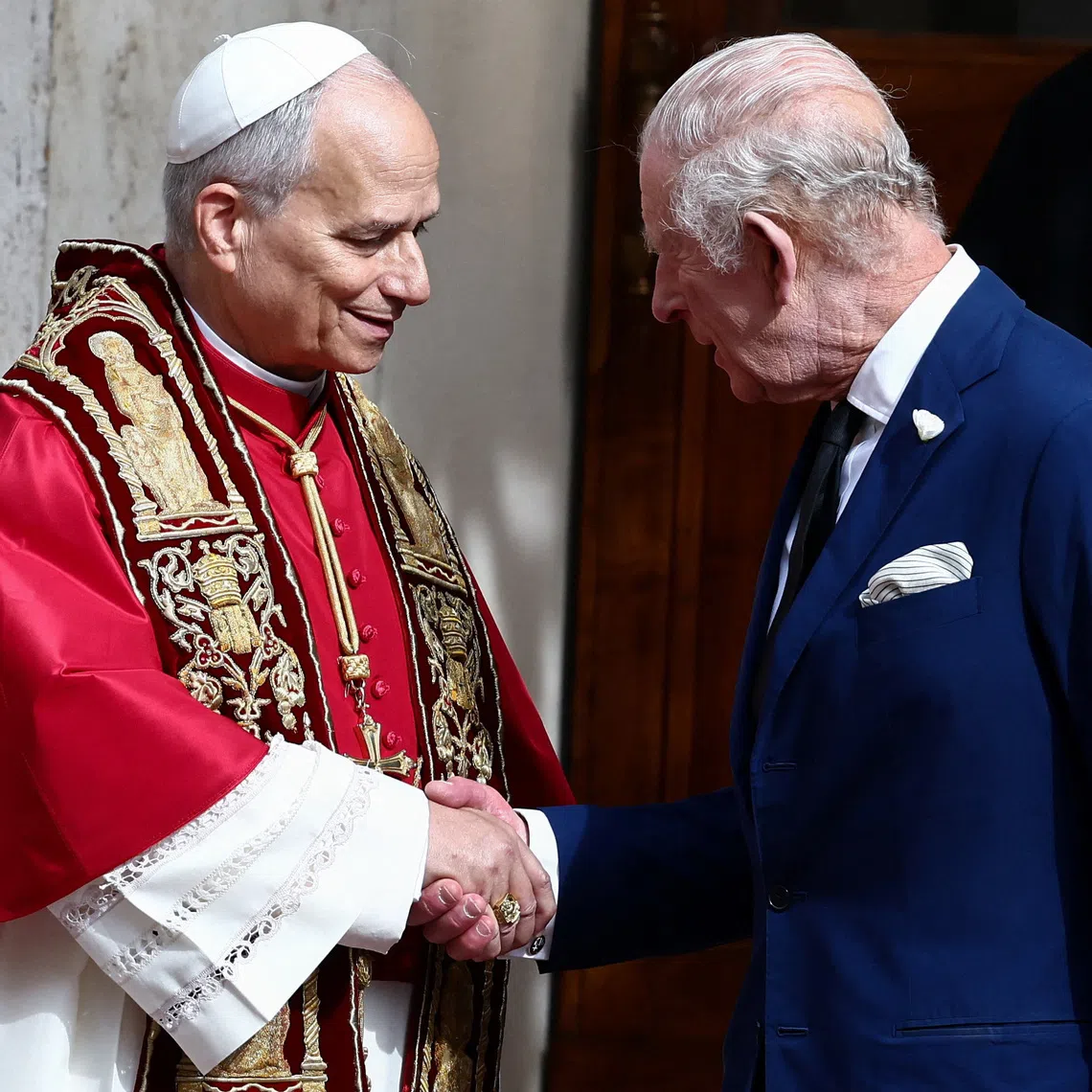 Britain's King Charles shakes hands with Pope Leo XIV in the courtyard of San Damaso, following an ecumenical prayer in the Sistine Chapelle led by the Pope and Archbishop of York Stephen Cottrell, at the Vatican, October 23, 2025. REUTERS/Yara Nardi