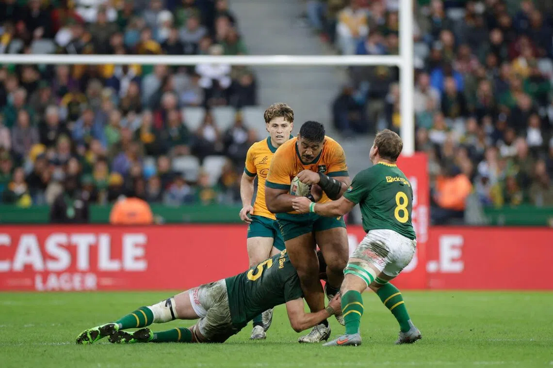 Australia lock Will Skelton is tackled by South Africa lock Ruan Nortje and No. 8 Kwagga Smith in the Rugby Championship Test match at the DHL Stadium in Cape Town on Aug 23, 2025.