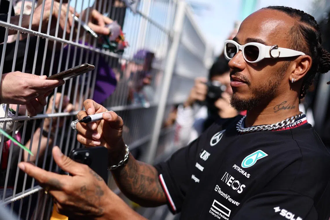 Mercedes driver Lewis Hamilton signs autographs on the Circuit de Monaco in Monte Carlo.