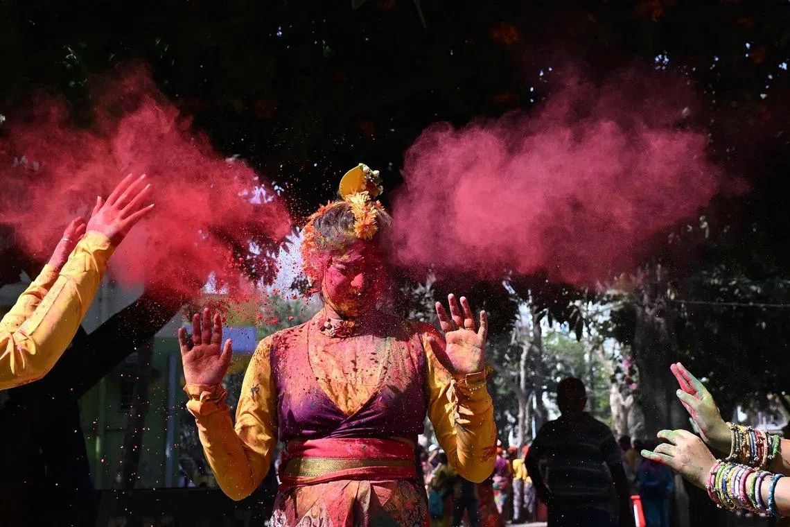 A woman is smeared with coloured powder as she celebrates Holi, the Hindu spring festival of colours in Kolkata, on March 3, 2026. 
