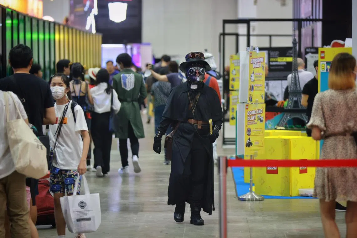 A cosplayer dressed as a medieval plague doctor browsing the show floor during Singapore Comic Con at the Sands Expo & Convention Centre on Sunday (Dec 11, 2022). 
