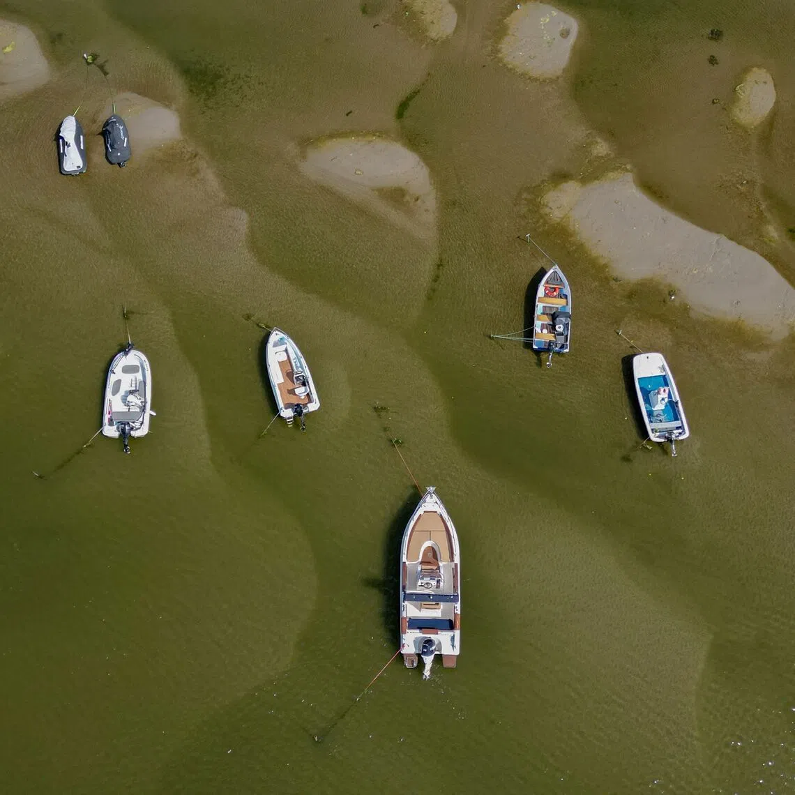An aerial view of boats in the shallow water of the Danube river in Corabia, southern Romania, on July 24. Nuclear plants along the Danube river in Hungary and Romania could be completely shut down in the coming days owing to record low water levels.
