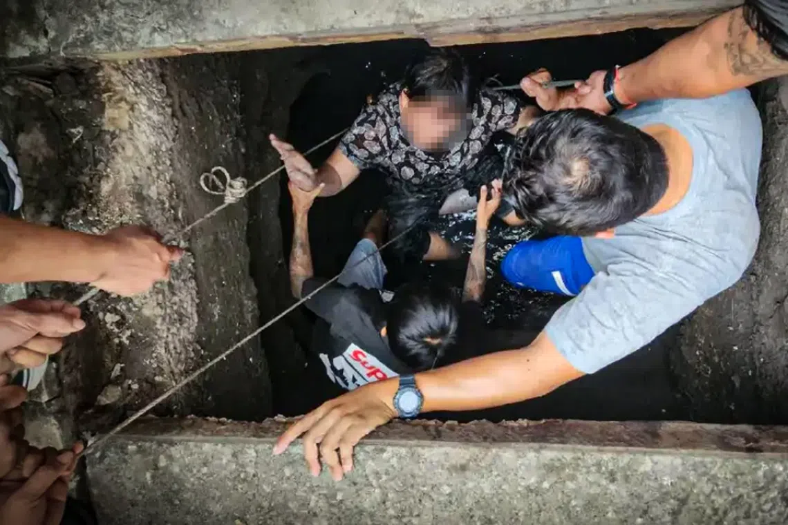 The 54-year-old woman was trapped in the manhole for nearly half an hour until a passer-by finally noticed her and called for help.