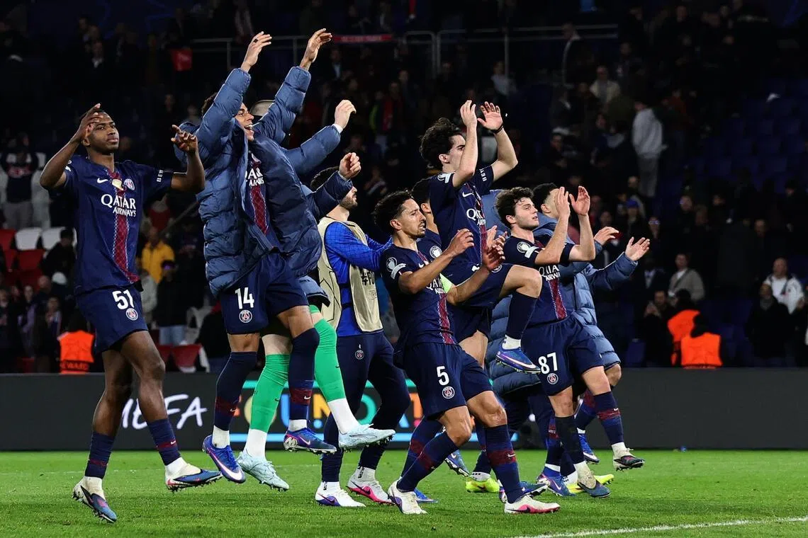 Paris Saint Germain players celebrate edging into the Champions League’s last 16 after a 2-2 home draw.