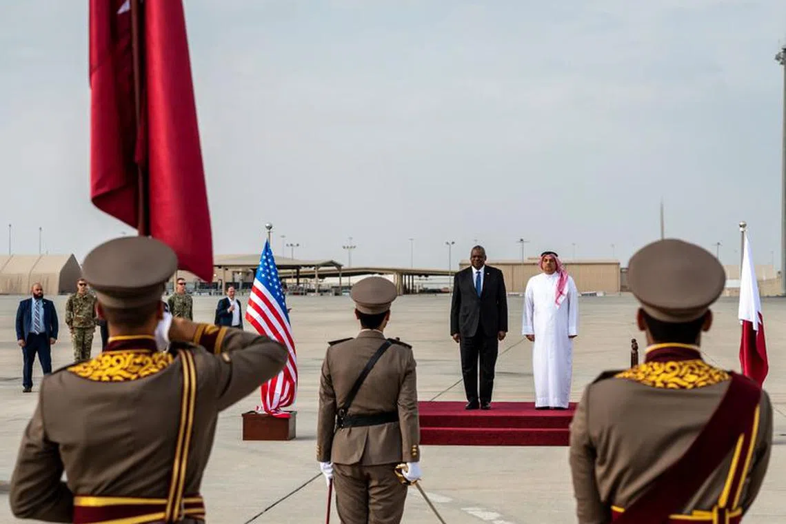 U.S. Secretary of Defense Lloyd Austin is welcomed by Qatar's Minister of Defense Khalid bin Mohammad Al Attiyah, during his visit to Al Udeid Air Base, Doha, Qatar, December 19, 2023. Sarah Williams/U.S. Air Force/Handout via REUTERS/File Photo