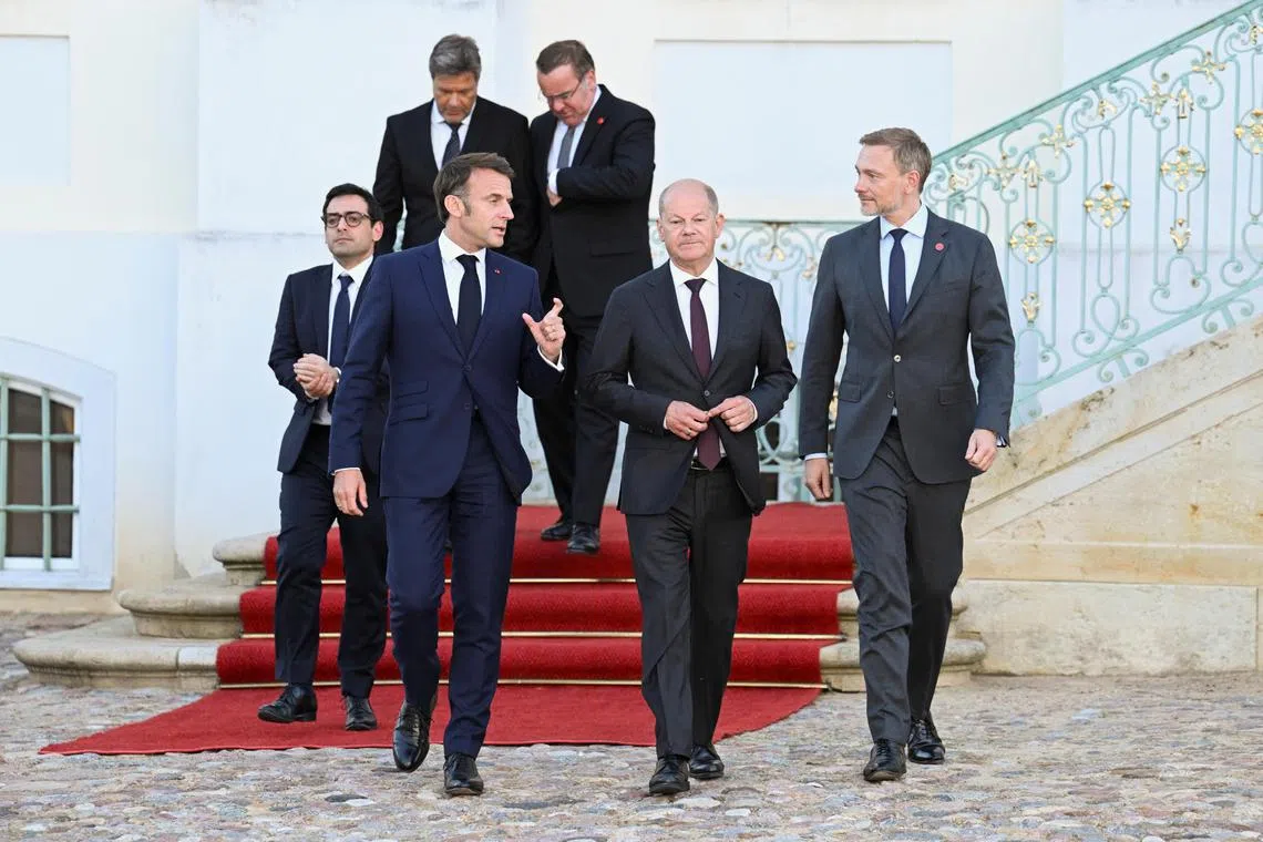 (Front, from left) French President Emmanuel Macron, German Chancellor Olaf Scholz and German Finance Minister Christian Lindner meeting in Gransee, Germany, on May 28.