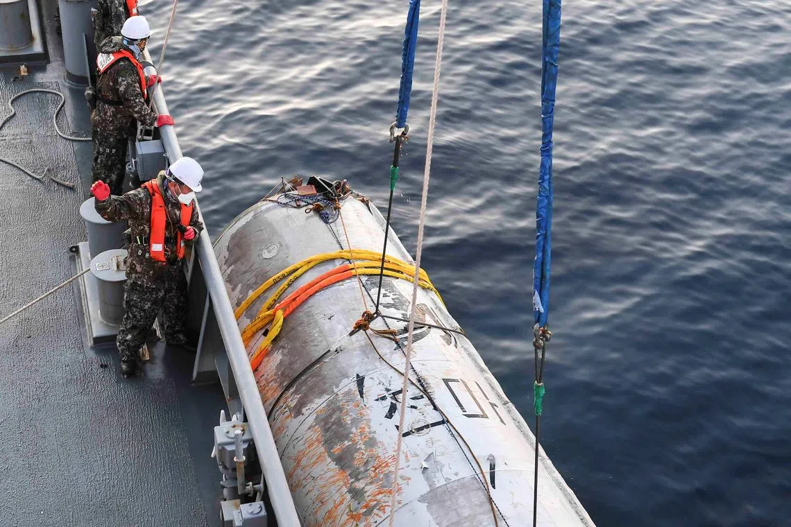 Photographs released by the South Korean military showed a large cylindrical object.