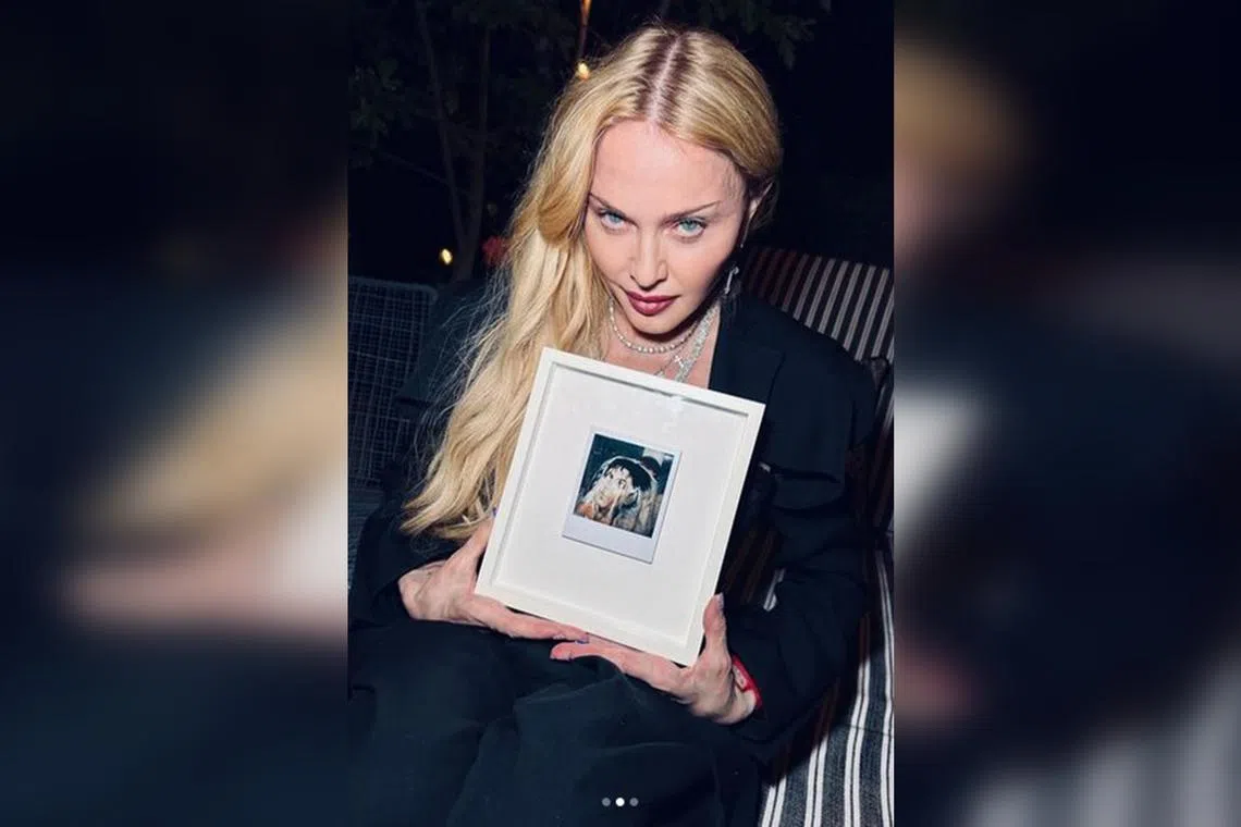 Madonna with a gift given by her manager Guy Oseary.