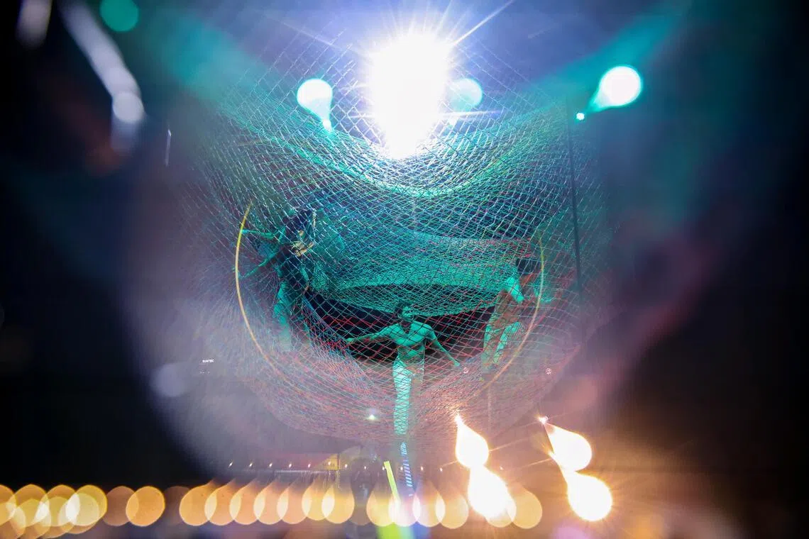Performers suspended above the ground inside a giant aerial net during a rehearsal for Noli Timere at Empress Lawn on May 14.