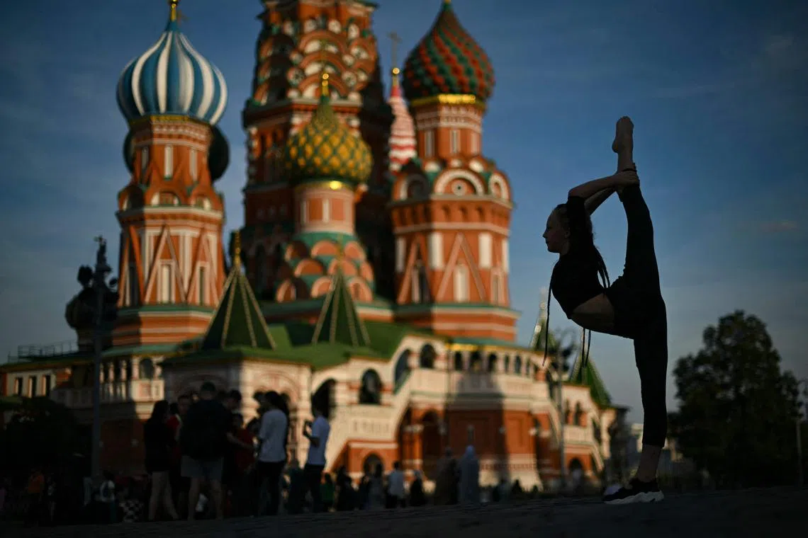 A girl posing on Red Square in front of St. Basil's Cathedral in central Moscow on Sep 9, 2024. 