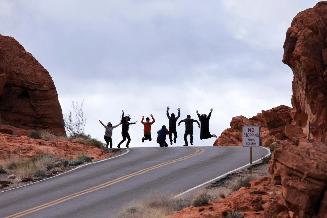 Tourists from South Korea jumping as they take a group photo near Elephant Rock in the Valley of Fire State Park, Nevada, U.S. Feb 7, 2024. 