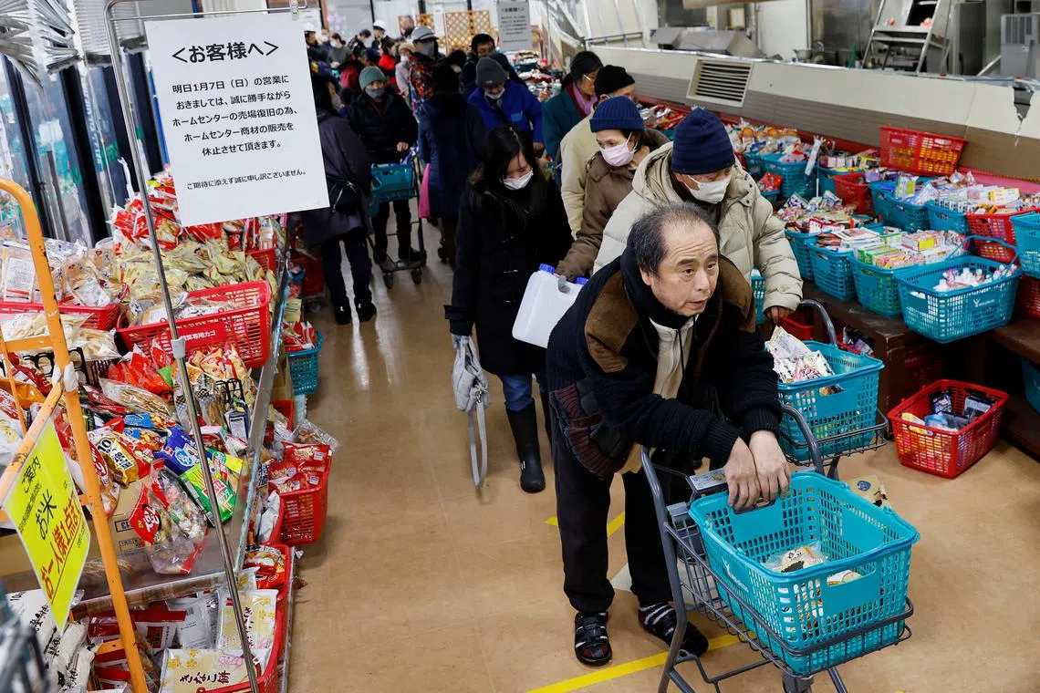 Residents standing in a line to buy goods at a reopened supermarket which was damaged by the earthquake, in Wajima, Ishikawa Prefecture, Japan, Jan 6, 2024. 