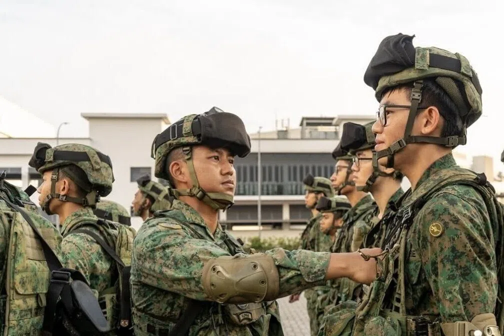 cpt alfian presents the 3rd singapore infantry brigade patch to one of his dedicated platoon sergeants during a parade