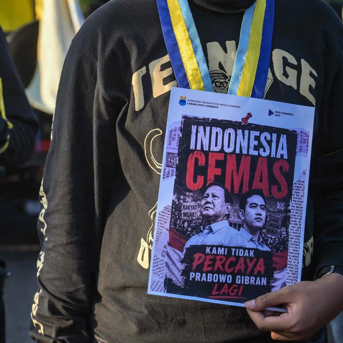 Protesters with posters of Indonesian President Prabowo Subianto and Vice-President Gibran Rakabuming Raka outside the provincial parliament building in Surabaya on June 19.