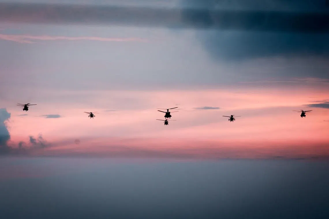 One S-70B Seahawk, two AH-64D Apache Attack Helicopters, two H225M Medium Lift Helicopters and one CH-47 Heavy Lift Helicopter in a helicopter formation flypast during the NDP 2025 at the Padang as seen from MBS SkyPark Observation Deck on Aug 9, 2025.