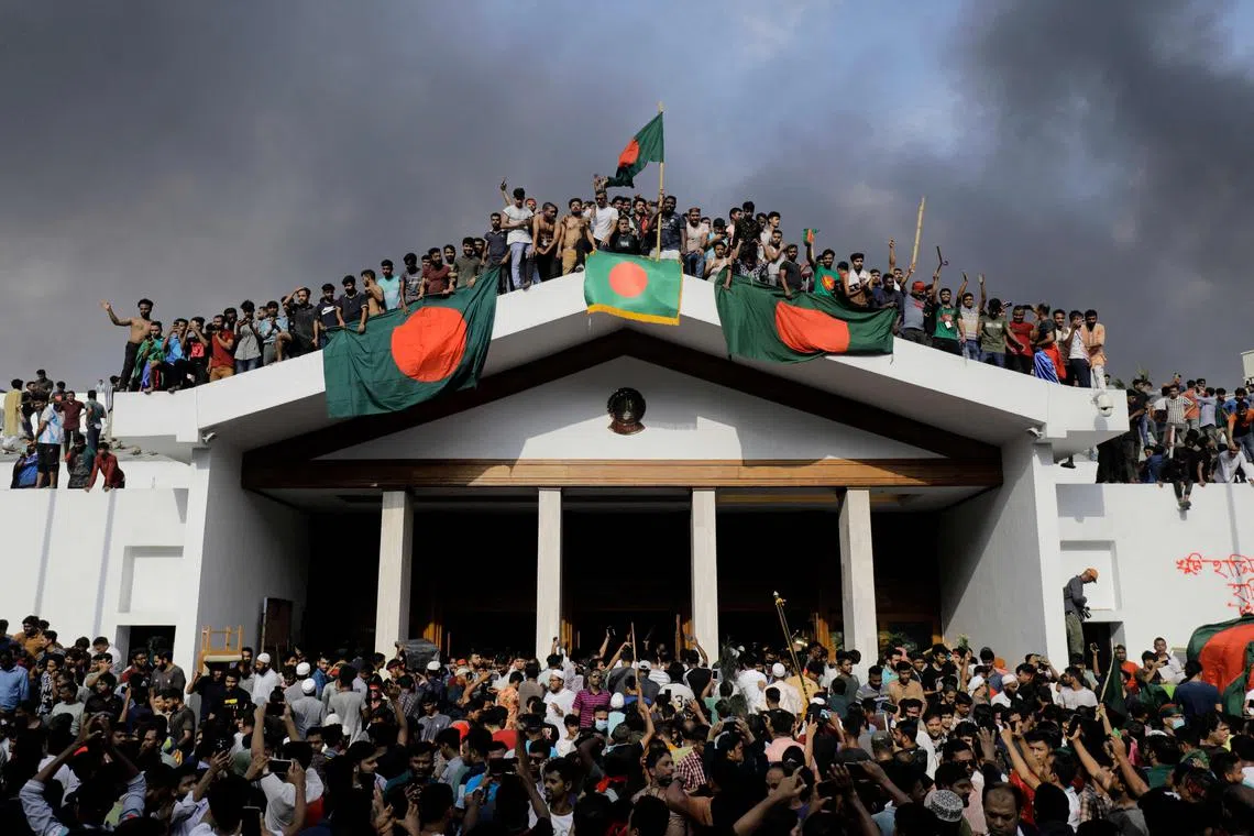 Anti-government protesters storm former Prime Minister Sheikh Hasina's palace in Dhaka on Aug 5, 2024.