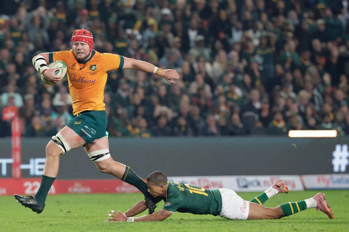 Australia's No. 8 Harry Wilson running with the ball to score one of his two tries as South Africa fly-half Manie Libbok misses a tackle during the Rugby Championship first round Test match between South Africa and Australia at the Ellis Park in Johannesburg on Aug 16, 2025. The Wallabies, who had not beaten South Africa at Ellis Park since 1963, recovered from trailing 22-0 to beat the reigning world champions and Rugby Championship title-holders 38-22.