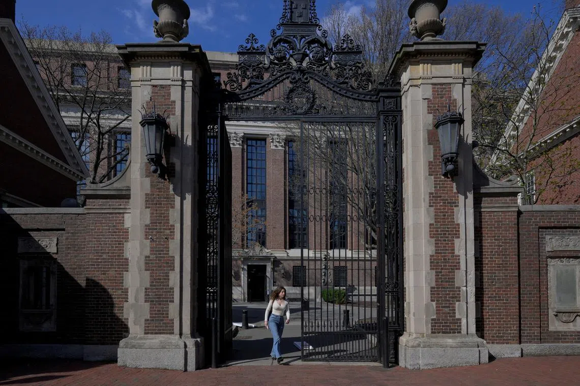 FILE PHOTO: A woman walks on the campus of Harvard University in Cambridge, Massachusetts, U.S., April 15, 2025.   REUTERS/Faith Ninivaggi/File Photo