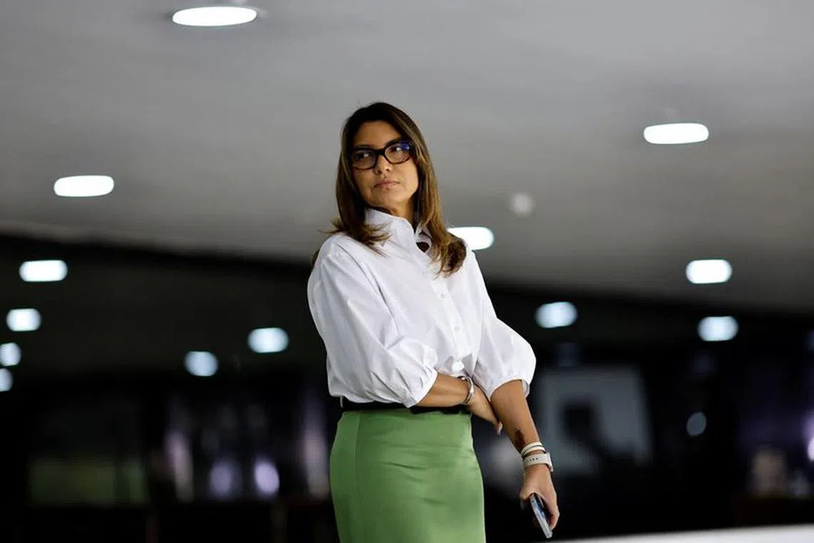 FILE PHOTO: Brazil's first lady Rosangela \"Janja\" listens to Brazil's President Luiz Inacio Lula da Silva during a ceremony of the Future Fuel Program Bill at the Planalto Palace in Brasilia, Brazil September 14, 2023. REUTERS/Ueslei Marcelino/File Photo