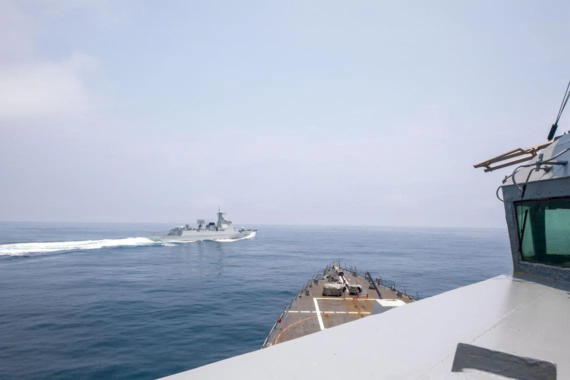 Chinese warship Luyang III sailing near the US destroyer USS Chung-Hoon, as seen from the deck of US destroyer, in the Taiwan Strait on  June 3 in this handout picture.