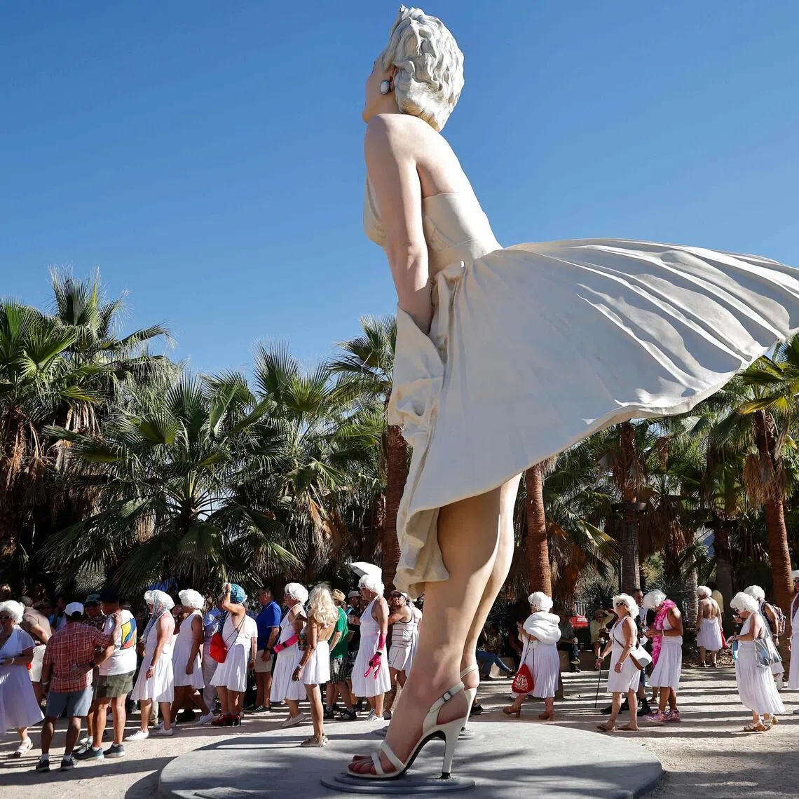 Participants dressed as Marilyn Monroe walk near the Forever Marilyn statue during the Marilyn Monroe 100th birthday celebration on May 30 in Palm Springs, California. 