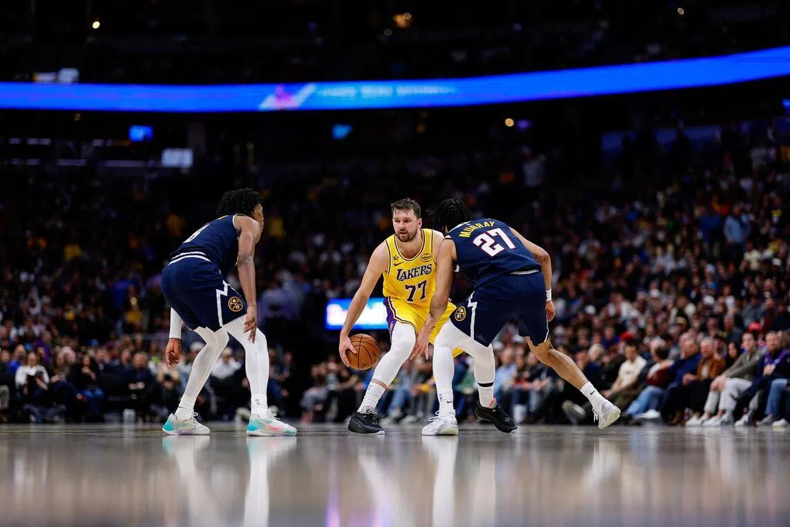 Los Angeles Lakers guard Luka Doncic controls the ball against the Denver Nuggets in the fourth quarter at Ball Arena.