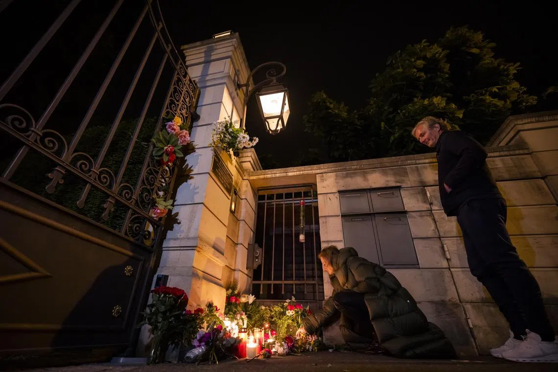 epa10651604 People light candles and lay flowers at the gate of the house of singer and stage performer Tina Turner in Kuesnacht, Switzerland, 24 May 2023. Turner, the unstoppable singer and stage performer, died Tuesday, after a long illness at her home in Kuesnacht near Zurich, Switzerland, according to her manager. She was 83.  EPA-EFE/MICHAEL BUHOLZER