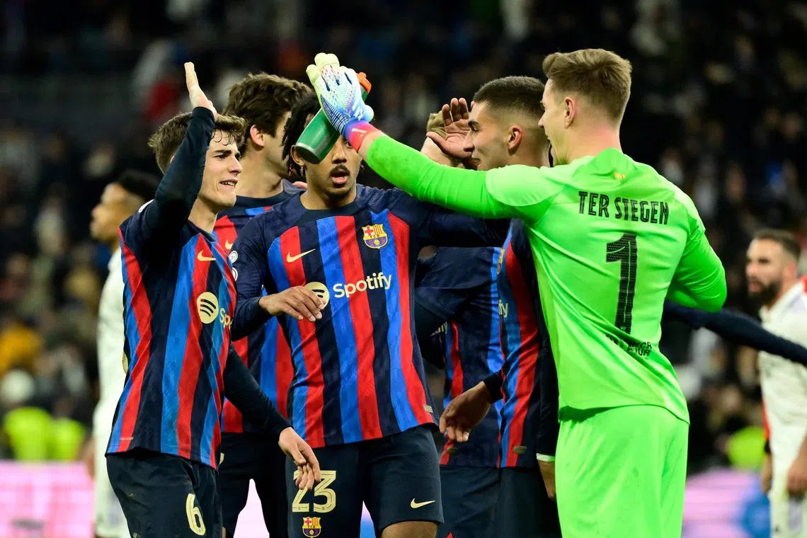 Barcelona players celebrate at the end of the match.
