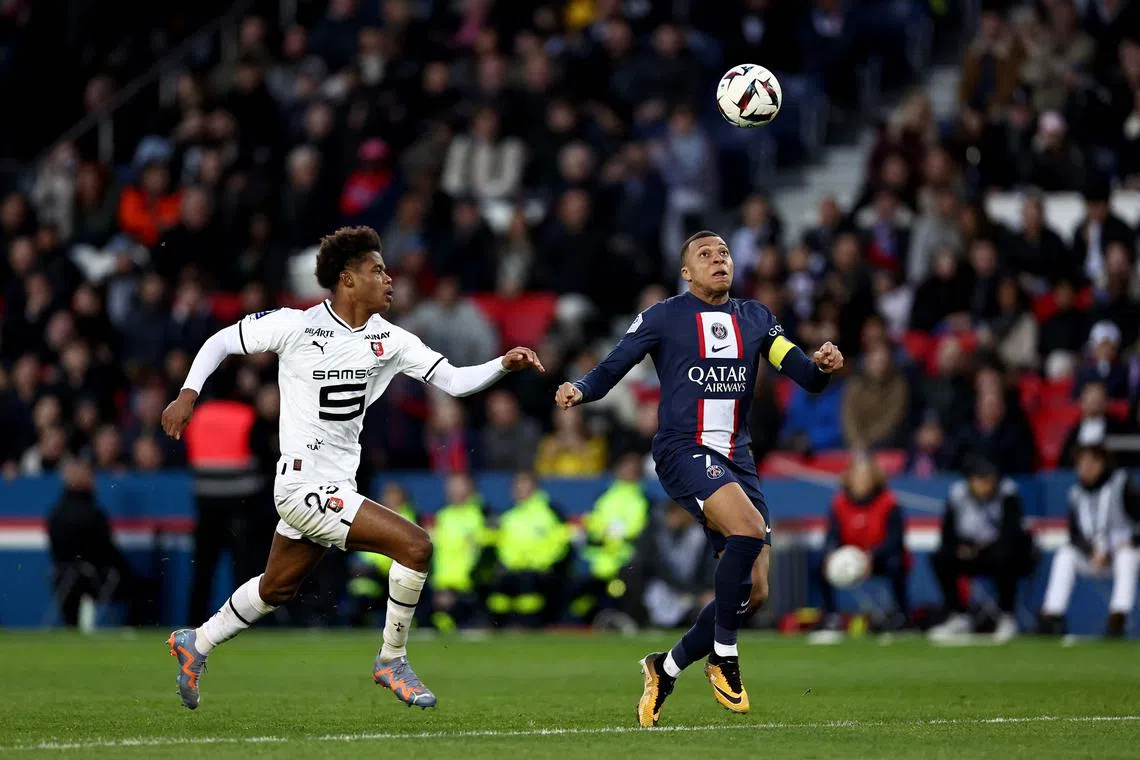 Rennes' French defender Warmed Omari (left) fights for the ball with Paris Saint-Germain's French forward Kylian Mbappe.