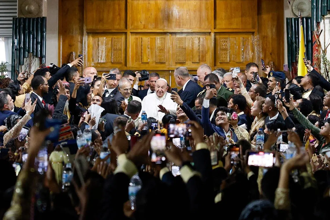Pope Francis greeting people at the Presidential Palace in Dili on Sep 9, 2024. 