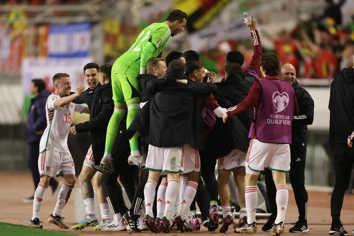 Wales' Nathan Broadhead celebrating with his teammates after scoring the equaliser that earned his side a 1-1 away draw against Croatia in Euro 2024 qualifying.