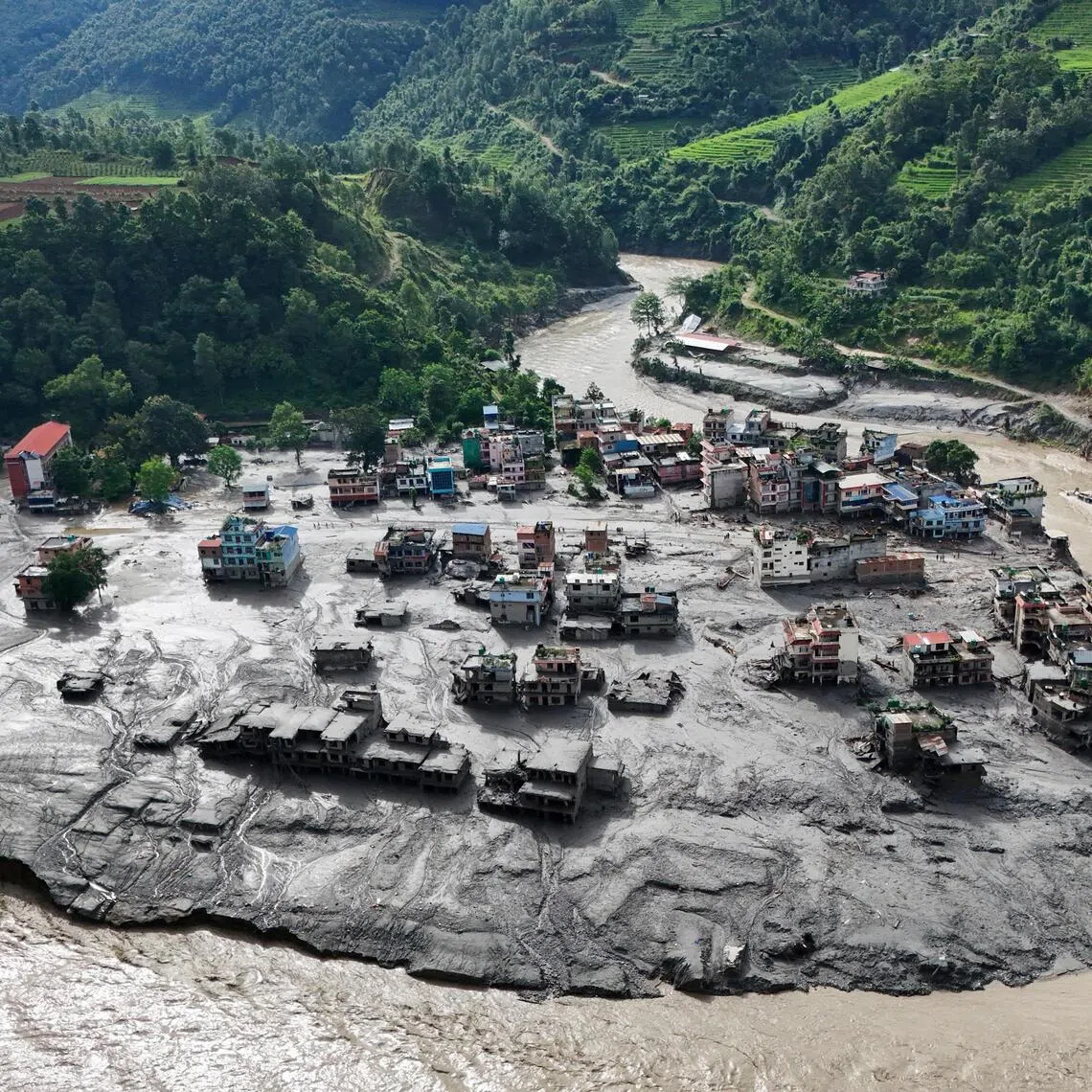 A drone view shows mud covering buildings and property following devastating floods in Nepal on Aug 27.