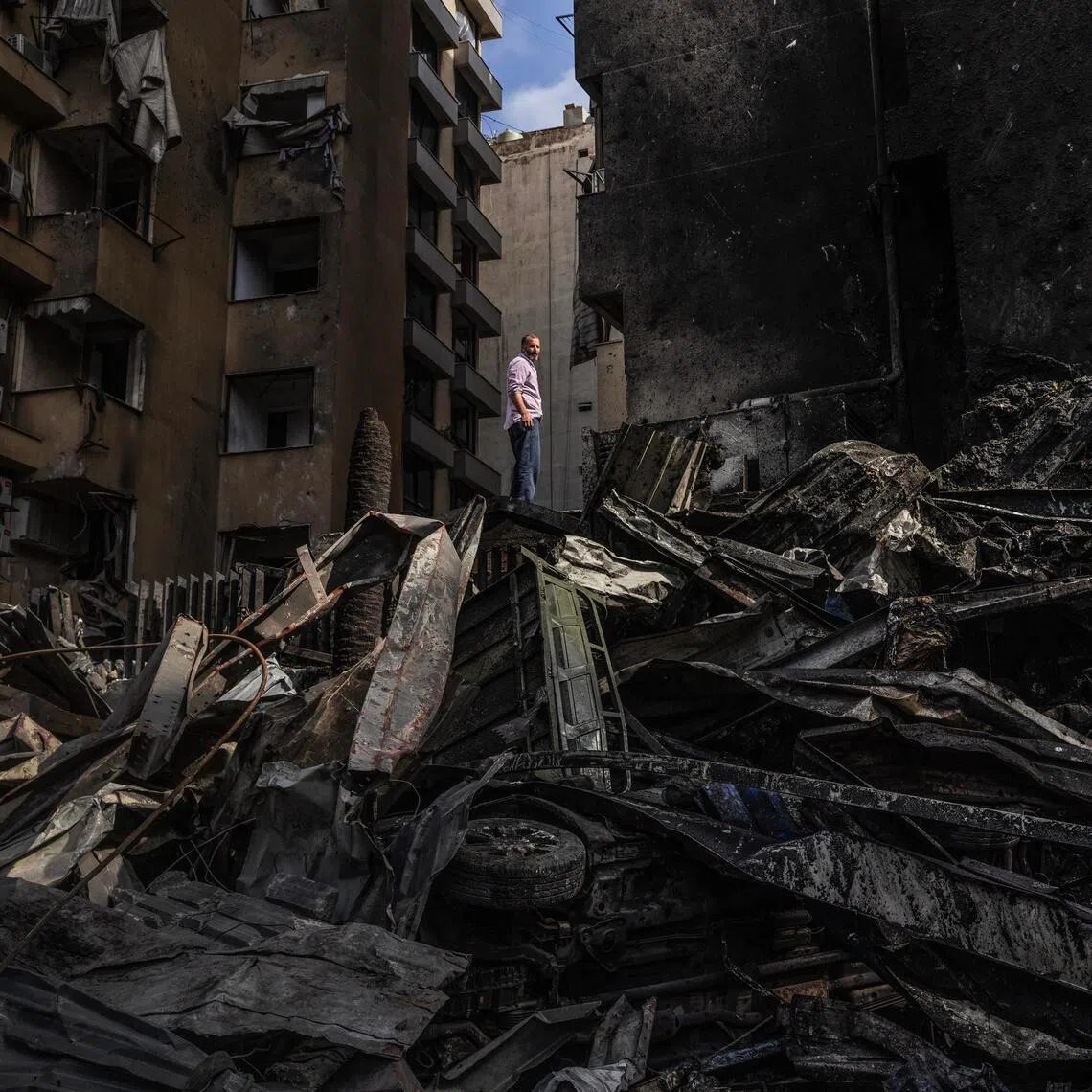 A Lebanese stands on a pile of debris in the Corniche El Mazraa area of Beirut after an Israeli bombardment of the capital.