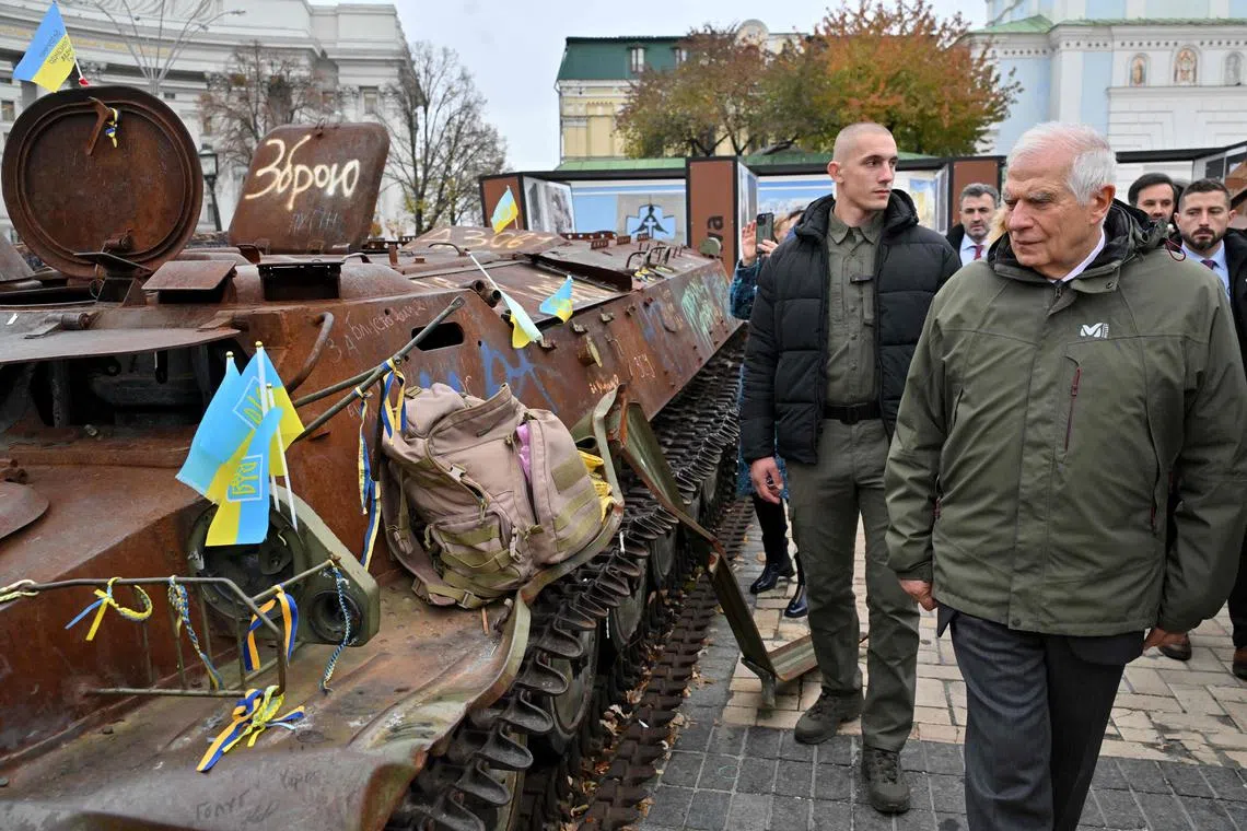 Mr Borrell (right) eaxmines destroyed Russian military equipment at an open air exhibition in Kyiv.