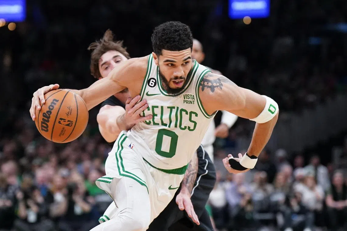 Boston Celtics forward Jayson Tatum driving past Brooklyn Nets forward Joe Harris in the 139-96 mauling on Wednesday.