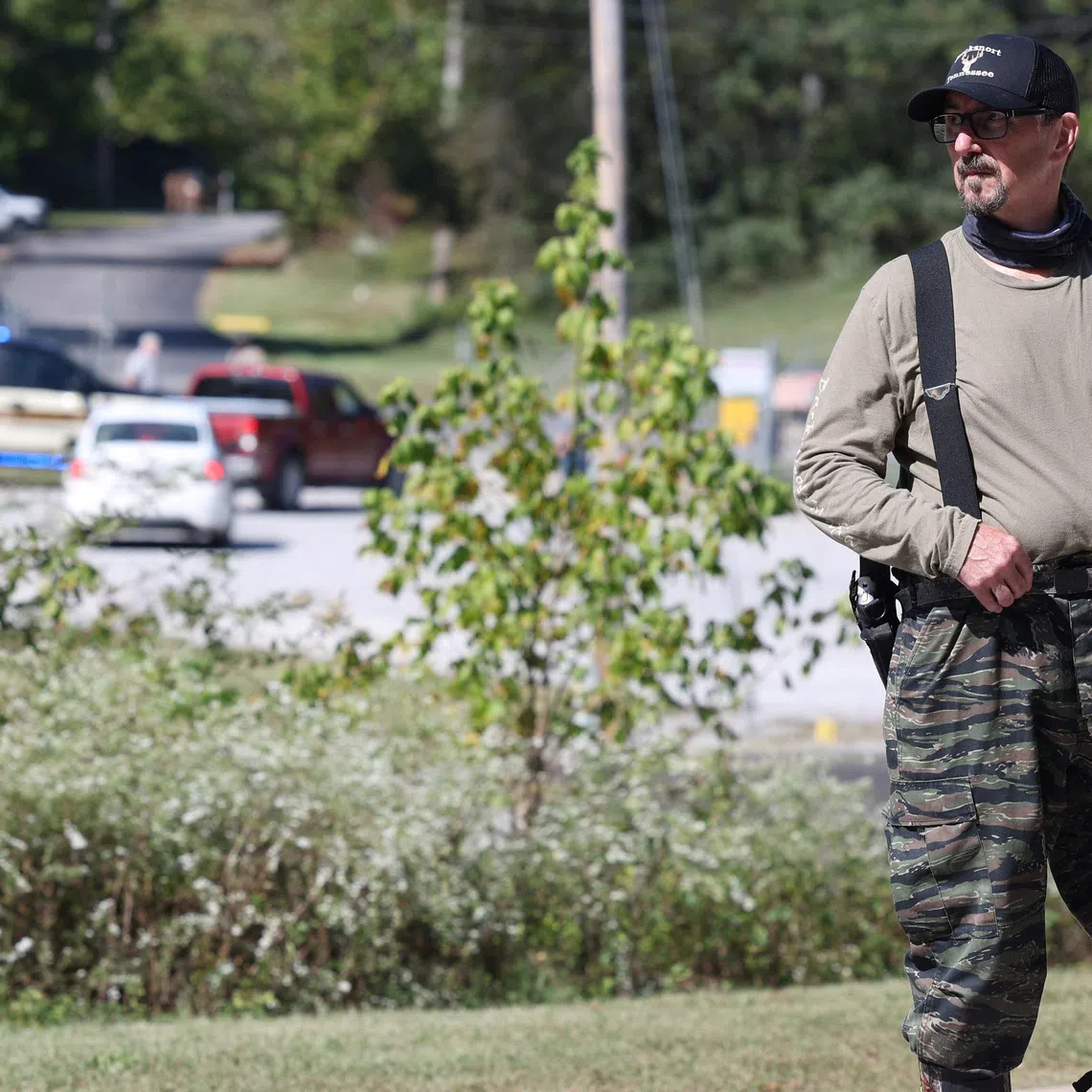 A law enforcement officer guards a gate outside the Accurate Energetic Systems military explosives plant, after an explosion at the facility in Bucksnort, Tennessee, on Oct 10.